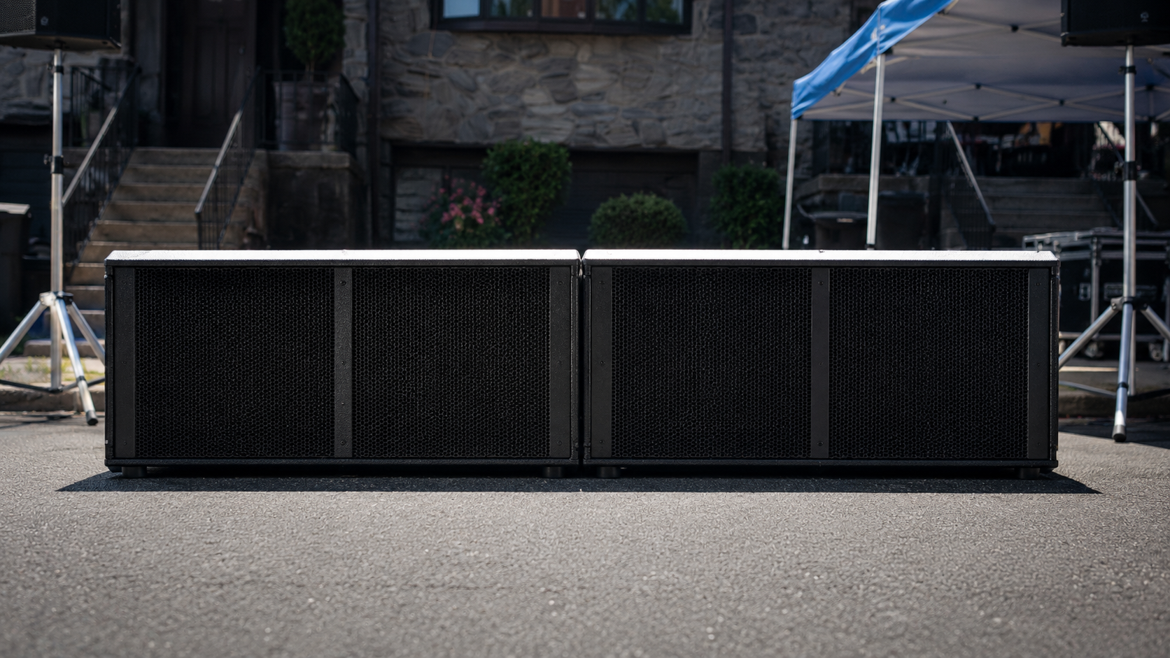 Miki Stage Sub cinema subwoofer — a matte-black enclosure with its Faital driver behind a steel grille.